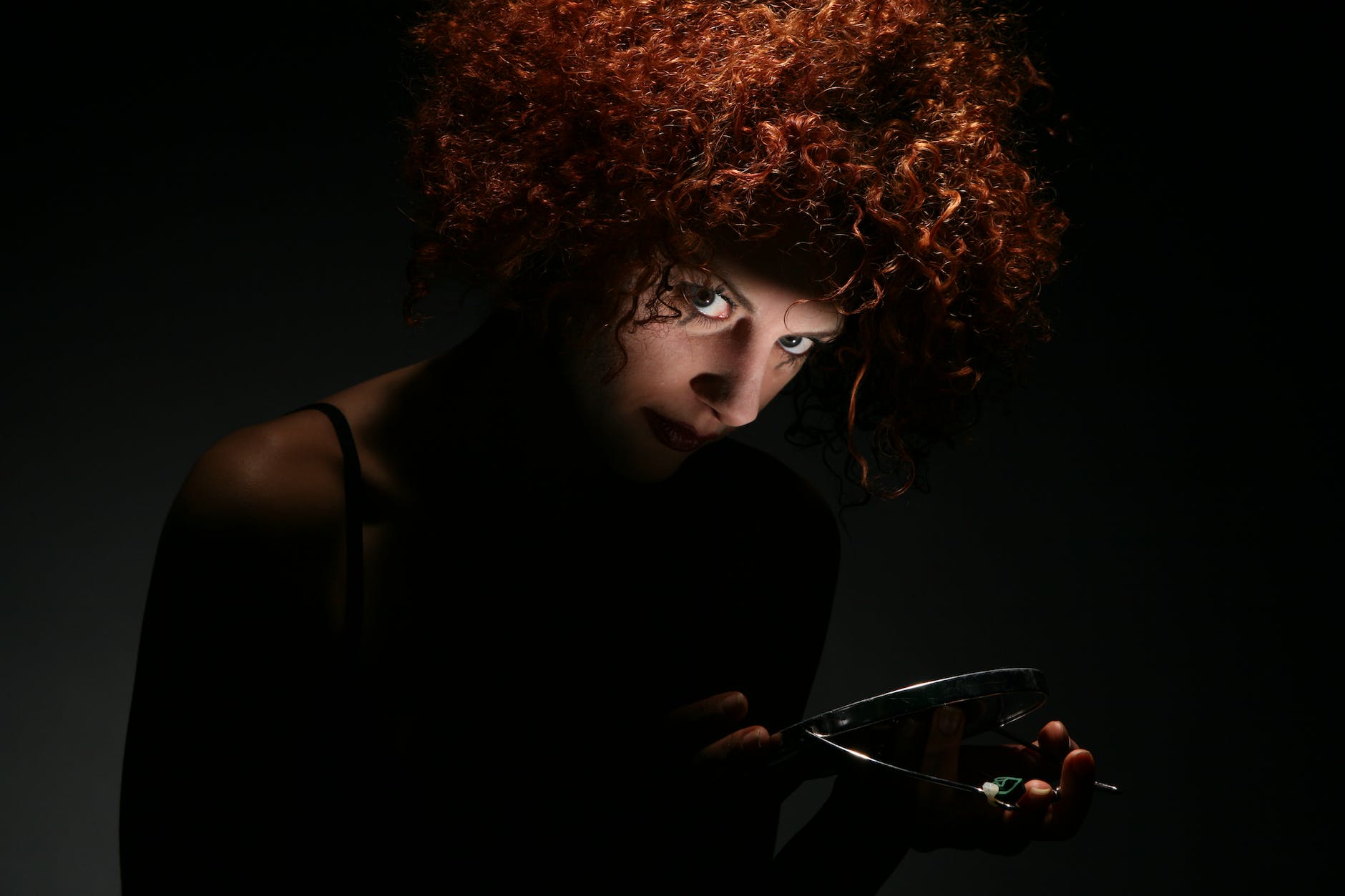 red haired woman in dark room